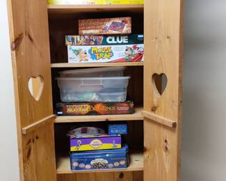 Assorted games in wooden cabinet