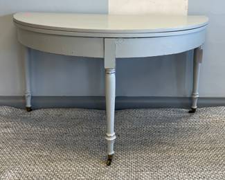 Antique Flip-Top Demi-Lune Table on Casters in Dove Grey Finish. Measures 54" W x 26" D x 31" H. Great As Demi-Lune But Also Works As An Entry Table.
