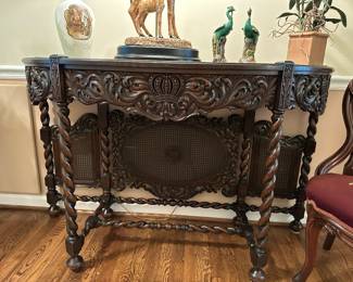 Jacobean style console table with twist turned legs and cane backing.