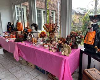 A wide array of Halloween & Thanksgiving decorations including Charlie Brown & Lucy and a Dept. 56 pitcher with dried flower arrangement.