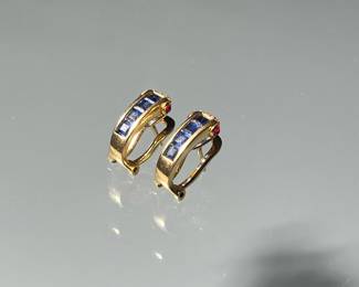 PAIR SAPPHIRE, RUBY, DIAMOND & 18K EARRINGS | Designed a line of 4 channel set square cut sapphires flanked by two cabochon rubies and melee diamonds
0.75 in., 4.8g. marked "750" and with makers mark