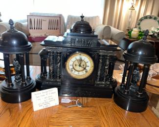 Antique Ansonia black slate clock, three pieces. Very rare to find with the side pieces clock not frozen, will chime, but will not stay running. Needs cleaning includes key bargain! $1295  

And working condition when you can find it this runs about $4000