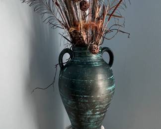 Large ceramic vase on plaster pedestal