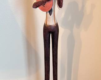 Hand carved wood man with guitar