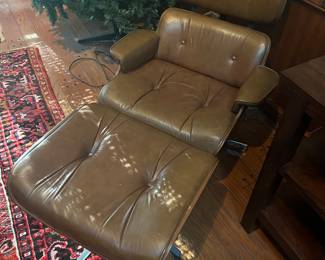 Vintage Ames chair and ottoman. Spots are sun shining in window
