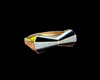 14k Yellow Gold Hinged Bangle Bracelet.  Trade marked MWD.  Bowtie design made from onyx and diamond.  64 round brilliant diamonds make up the center of bowtie while 4 tapered onyx pieces make up the outside.  Diamonds are eye clean, near colorless and have a total weight of approximately 1.5 carats.  Replacement Appraisal by Korona Jewelry at $4400.00