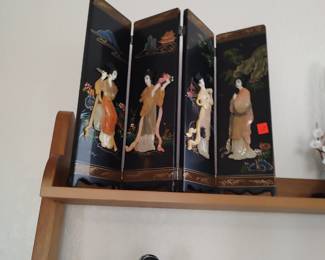 Small oriental screen with raised design.