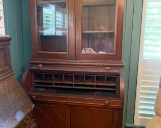 #82	Antique Desk w/2 glass doors & peg Sides  w/cubbies & 2 doors on the bottom and Shelf  - 1" Shelf  (Center Piece is stuck and center can't pull out)   48x22x89T - 2 pc - You Move	 $425.00 			

