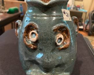 #213	Ugly man pottery  pitcher signed with a cork 9 inches tall 	 $75.00 			

