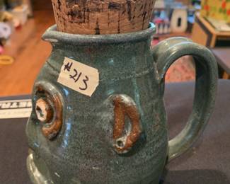 #213	Ugly man pottery  pitcher signed with a cork 9 inches tall 	 $75.00 			
