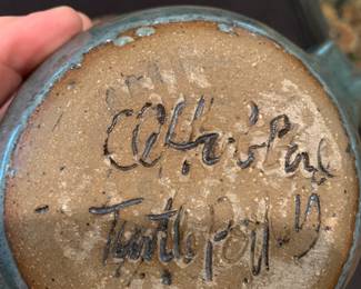 #213	Ugly man pottery  pitcher signed with a cork 9 inches tall 	 $75.00 			
