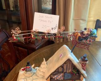 #215	Jim Shore "Dreams Fly" statue with Santa and house 	 $25.00 			
