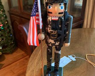 #216	Holiday Traditions army nutcracker with flag 14" tall	 $20.00 			
