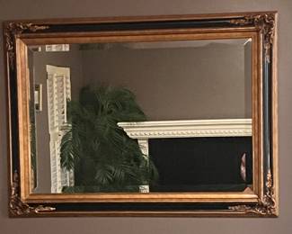                           Large ornate black and gold mirror