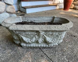 Antique grape/garland/faces concrete planter. 32” wide by 17” back to front by 12” high