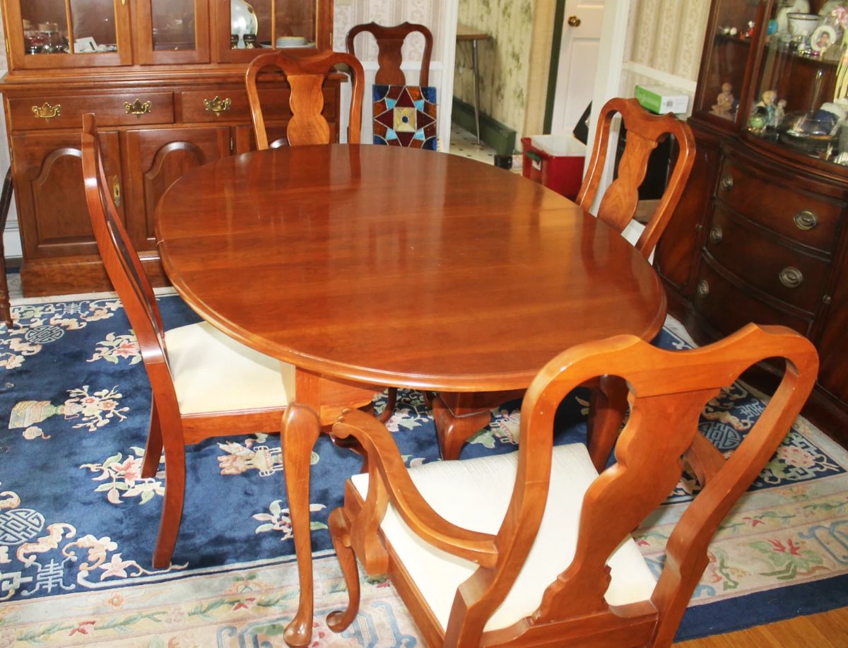 Hitchcock Furniture Dining Table with 3 Leafs and table pads.  Also, 5 Hitchcock Furniture Chairs.  Table and Chairs are available separately.