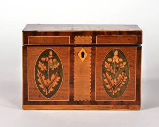 FANCY INLAID TEA CADDY | 19th Century
The lid having an inlaid shell within contrasting wood borders, the front with barber pole inlay and two reserves with acorns and leaves, fitted interior with two lidded compartments with bone handles and with inlay inside - l. 7.25 x w. 3.75 x h. 4.75 in.
