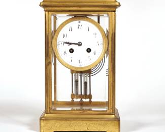 TIFFANY & CO. FRENCH SHELF CLOCK | Samuel Marti, having a white dial with painted enamel Arabic numeral markers, in a gilt bronze case with beveled glass panels, mercury pendulum, and a ring chime  - l. 7 x w. 5.5 x h. 11.25 in.
