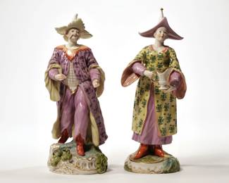 (2pc) FRANKENTHAL PORCELAIN FIGURES | 20th century, Chinoiserie porcelain figures, one depicting a lady holding a jug and the other depicting a gentleman, both wearing pointed hats and long robes - l. 4.5 x w. 4.5 x h. 11.25 in. (tallest)