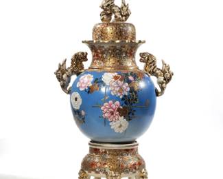 LARGE LIDDED CHINESE VASE ON STAND | Intricate and colorfully painted lidded Chinese vase with gilt foo dog figurine on top and side with highly decorated gilt pattern on neck leading to gilt accented flowers with conforming floral and gilt claw-foot base
 - h. 26.5 x dia. 11.5 in.