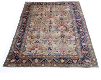 ANTIQUE TABRIZ CARPET | Having an overall pattern with leaves and vines and animals cream ground within a blue border with garlands and pineapples - l. 118 x w. 80 in.