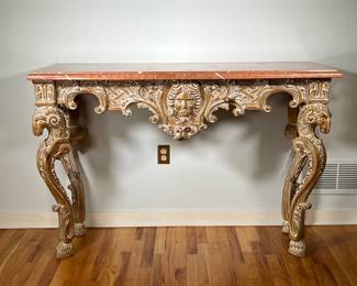 MARBLE TOP HALL TABLE | Italian Rococo Hall/console table with a variegated marble top resting on four ornately carved legs; made in Italy with a Firenze [Florence] label - l. 58 x w. 22.5 x h. 38 in.