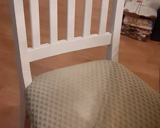 Four sturdy wooden chairs with light green seats.