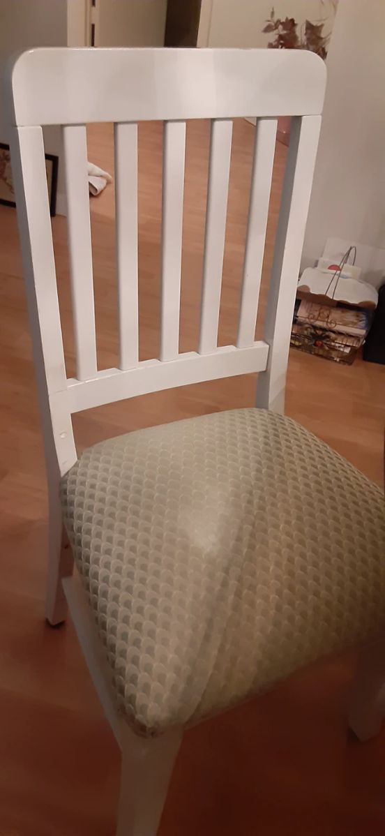 Four sturdy wooden chairs with light green seats.