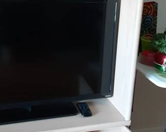 Entertainment center is washed modern color. 