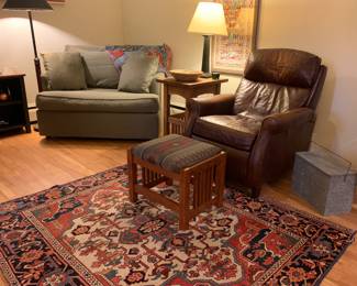 Leather recliner ottoman, rug may or may not be claimed by the family