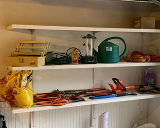 Jumper cables, tackle box, hedge trimmers, watering can, extension cords, lantern