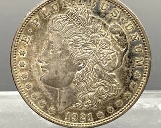 1921 US Morgan silver dollar coin.......To register in order to place bids go to www.capitolsalesservices.hibid.com 
