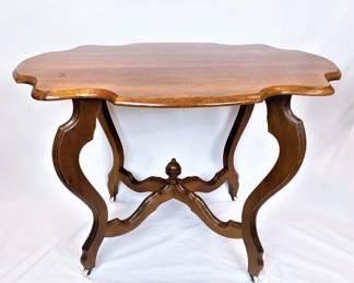 Antique parlor table, circa 1880 with porcelain caster wheels