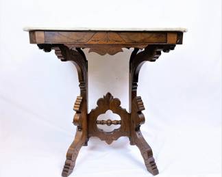 Victorian parlor table with a marble top, circa 1880. 
