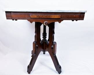 Victorian marble top parlor table, circa 1880.   This table has been in this house since it was custom built in 1978 for the Gillen family.  The home was sold to the current owner in 1990 from the original family and this table along with other pieces came with the house.  This table was refinished in the 1970s by Everett's Antiques of Corsicana.   Everett's was a premier family run antique business for decades.  