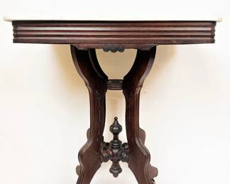 A Victorian marble top parlor table, circa 1880.  This table has been in this house since it was custom built in 1978 for the Gillen family.  The home was sold to the current owner in 1990 from the original family and this table along with other pieces came with the house.  This table was refinished in the 1970s by Everett's Antiques of Corsicana.   Everett's was a premier family run antique business for decades.  