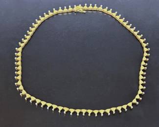 Gold (marked 750 which is 18k) necklace with Melee diamonds at each triangular point.  This set was purchased at  Hotel Grande Bretagne in Athens, Greece.  There is a set of matching earrings. ........To register in order to place bids go to www.capitolsalesservices.hibid.com 
