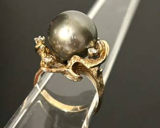 14k yellow gold and Tahitian black pearl with melee diamonds cocktail ring.  Size 8.   The late lady of this estate purchased this ring from a jeweler in Dallas many years ago who specialized in pearl jewelry.........To register in order to place bids go to www.capitolsalesservices.hibid.com     