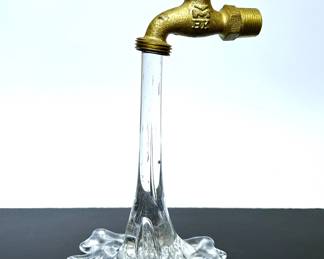 Pop Art Glass Sculpture of glass water pouring out of a brass faucet.   Designed by Gary Guydosh........To register in order to place bids go to www.capitolsalesservices.hibid.com 