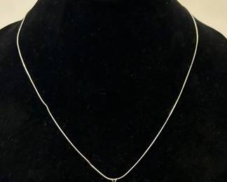 14k white gold necklace with a small diamond ........To register in order to place bids go to www.capitolsalesservices.hibid.com 