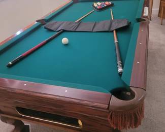 Very nice pool table with a new table cover, cue sticks, rack and cue holder