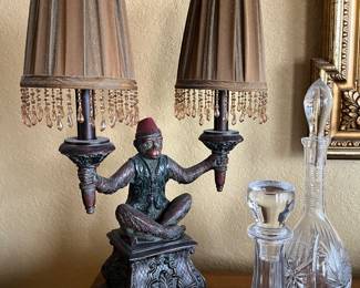 A pair of bell hop monkey lamps