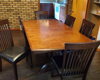 Rectangular dining table with a fold away leaf, shown open here.  Six very comfortable chairs!  Good quality.