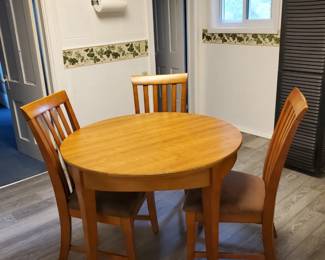 Cort Furniture round table and 5 chairs (2 not shown).  The top is veneer.  This set has a little mileage on it that is easily repaired.