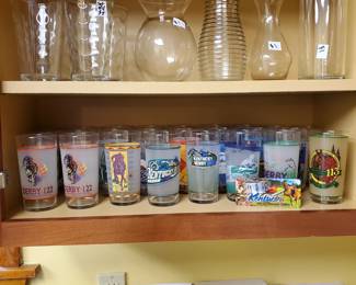 Nice selection of glass vases, 4 tall tumblers on top and a large collection of Kentucky Derby Mint Julep Glasses, non consecutively range from 1997 to 2023.  Some great cook books too.