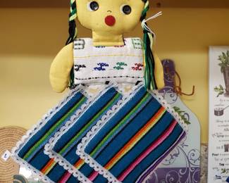 Hand Made in Guatamala, this little miss has 3 lovely hand loomed potholders attached by velcro for easy use.