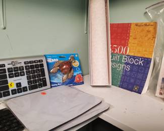 Blue tooth keyboards, mice, mats, scented drawer liner, turtle swimming toy from "Finding Nemo" and a book on Quilt block design.