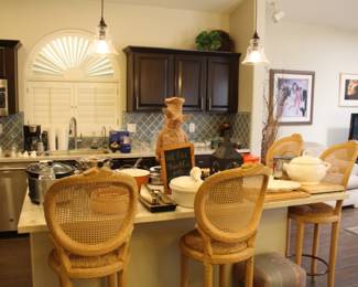 View of the kitchen with rush seat and cane back rustic bar chairs