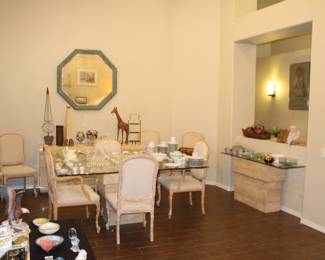 Dining room view with travertine base and beveled glass dining table and same style sofa/side table