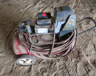 Lot 16. 20-gallon Magnetek compressor with hose. Powers up